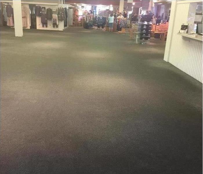 shopping mall floor with clothes in the back